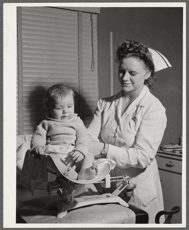 Nurse weighs baby at the well baby clinic at the Cairns General Hospital at the FSA (Farm Security Administration) farm workers' community. Eleven Mile Corner, Arizona