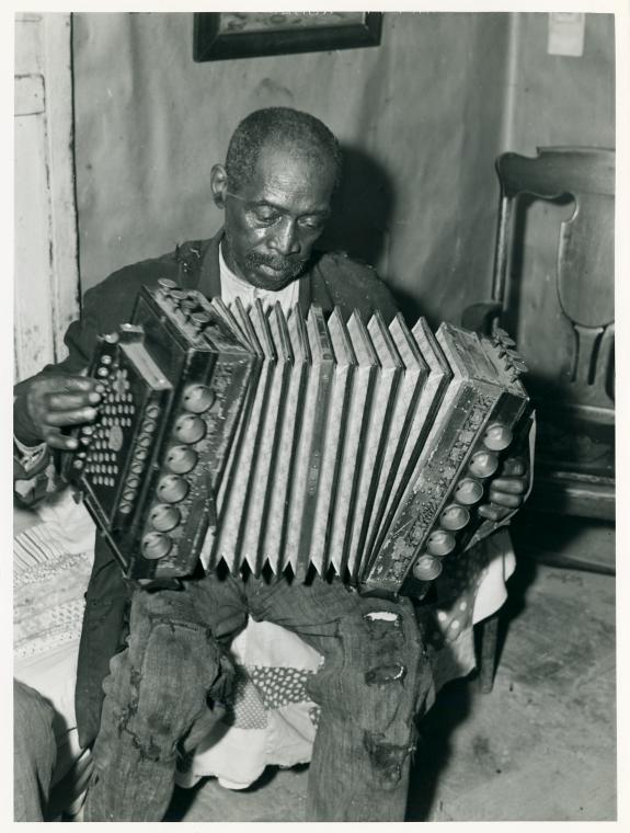 John Dyson, FSA (Farm Security Administration) borrower, playing the accordion; He was born into slavery over eighty years ago, St. Mary's County, Maryland, September 1940.