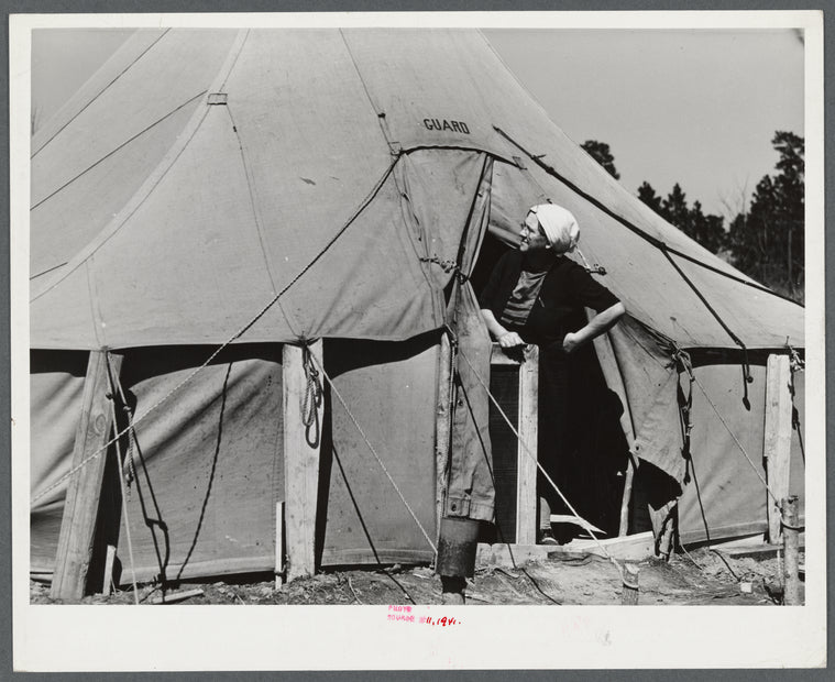 Woman living in a tent in a settlement for workers at Fort Bragg, near Fayetteville, North Carolina.