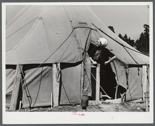 Woman living in a tent in a settlement for workers at Fort Bragg, near Fayetteville, North Carolina.