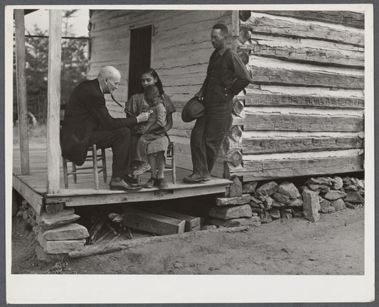 Dr. S.A. Malloy examining Louis Graves and his family on their front porch. They are FSA (Farm Security Administration) borrowers. Caswell County, North Carolina.