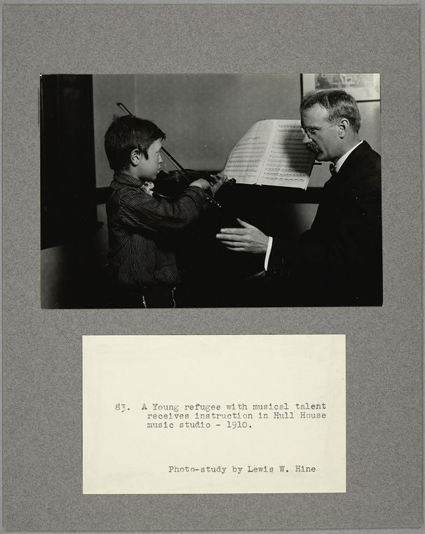 A young refugee with musical talent receives instruction in Hull House music studio, 1910