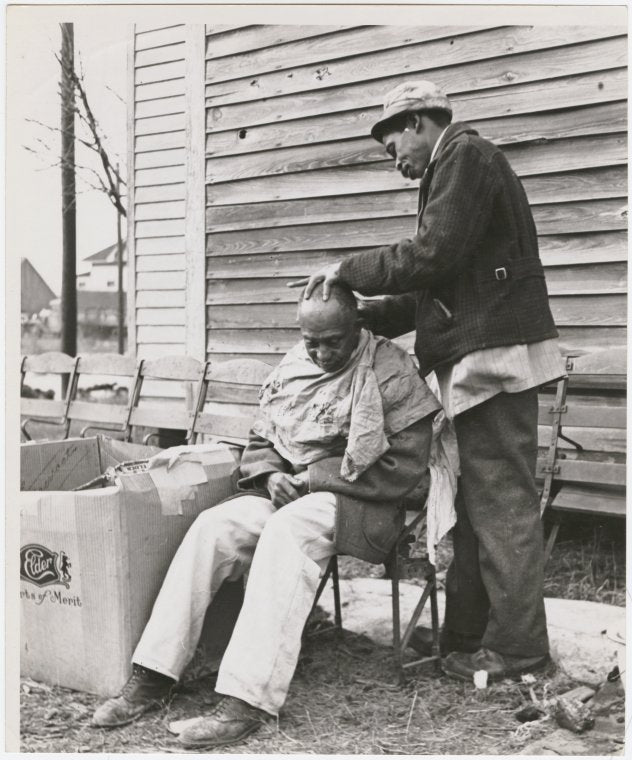 One man grooming another outdoors