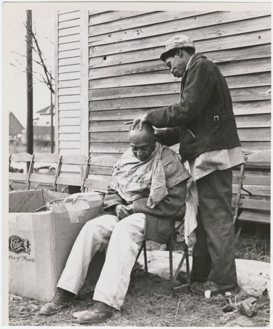 One man grooming another outdoors