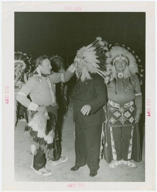 Amusements - Shows and Attractions - Wild West - Indian man putting headdress on Grover Whalen