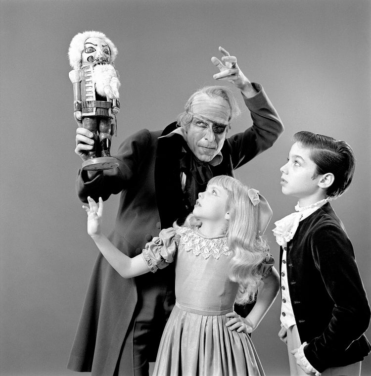 Judith Fugate as Clara, John-Pierre Frohlich as the nephew and  Shaun O'Brien as Drosselmeyer, in a New York City Ballet production of "The Nutcracker."