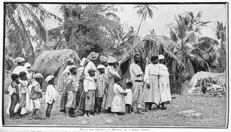 Wives and children of workers on a sugar estate.