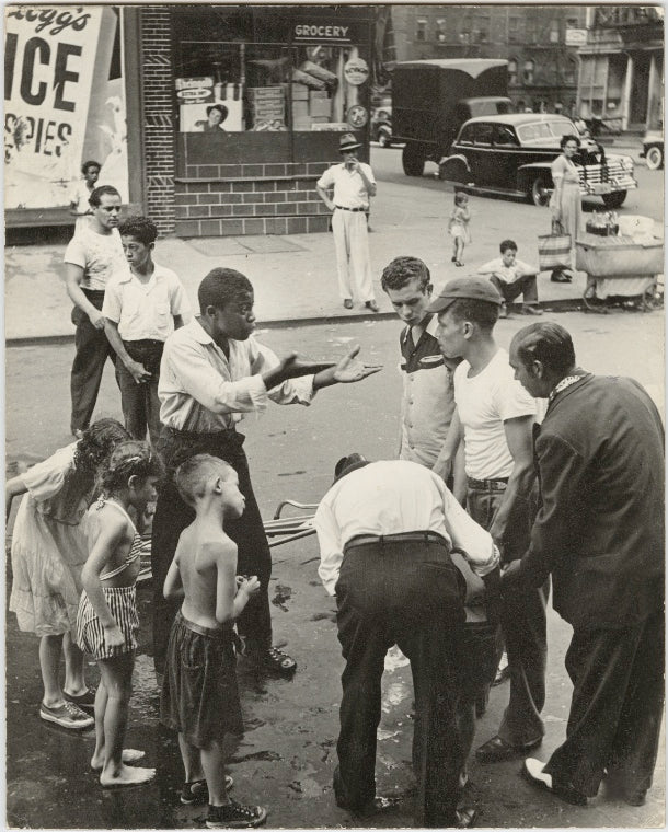 Eastside - Group of men and youths gathered around an accident victim; one young man appears to be arguing with the others, East Harlem, New York City