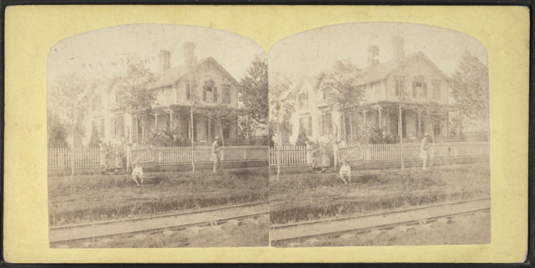 View of a home with railroad track in front.
