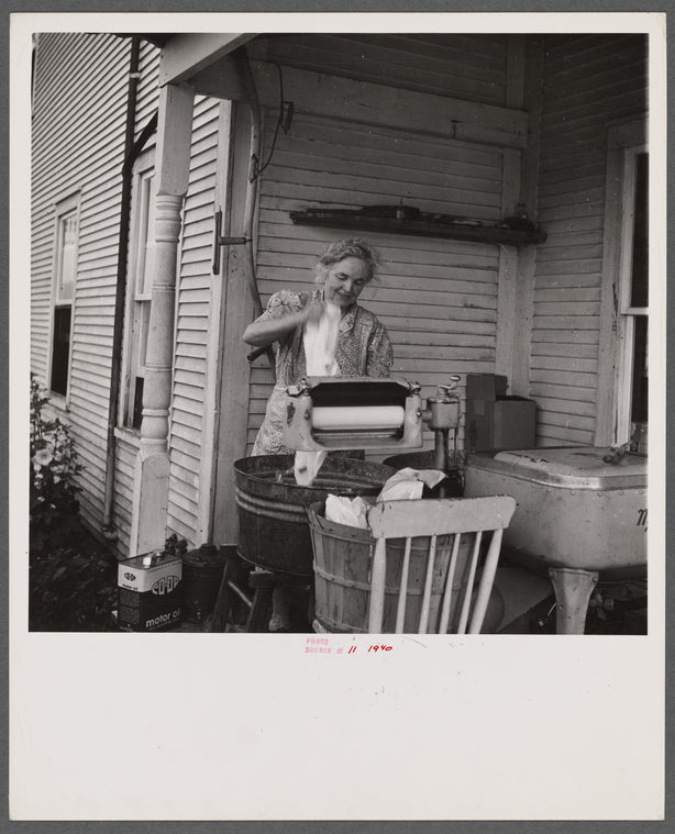 Farm woman washing clothes in her motor-driven washing machine. Near Lincoln, Vermont.