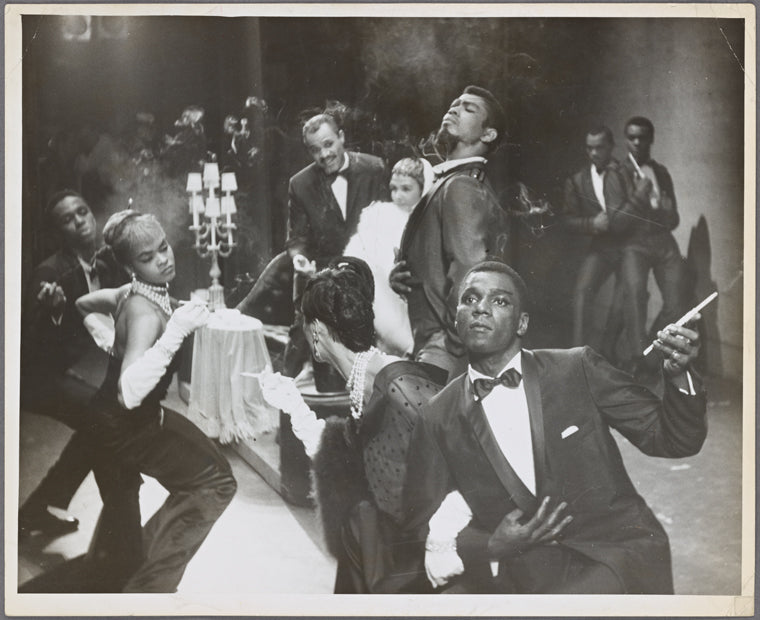 Scene from unidentified dance performance with Alvin Ailey (standing at center) and Charles Moore (in foreground)