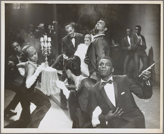 Scene from unidentified dance performance with Alvin Ailey (standing at center) and Charles Moore (in foreground)