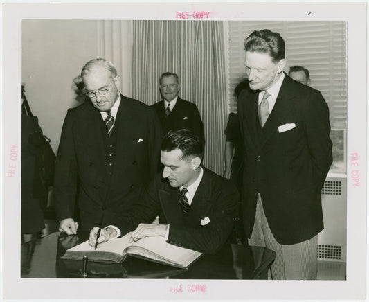 New Zealand Participation - Robert Firth (Commissioner General) signing contract with Harvey Gibson
