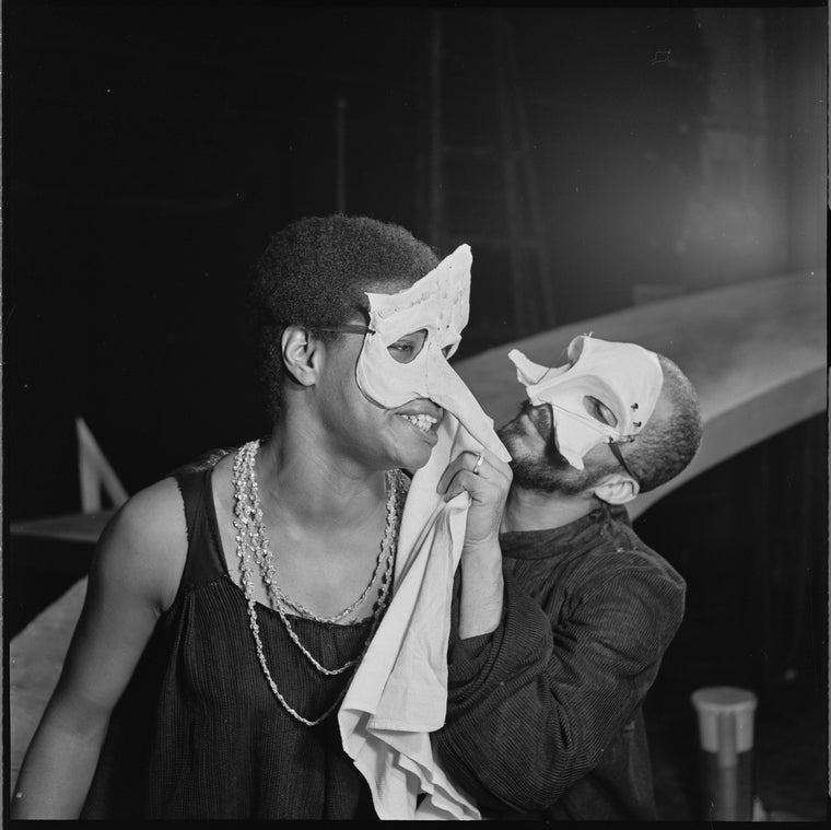 Maya Angelou and Charles Gordone (in masks) in the stage production The Blacks