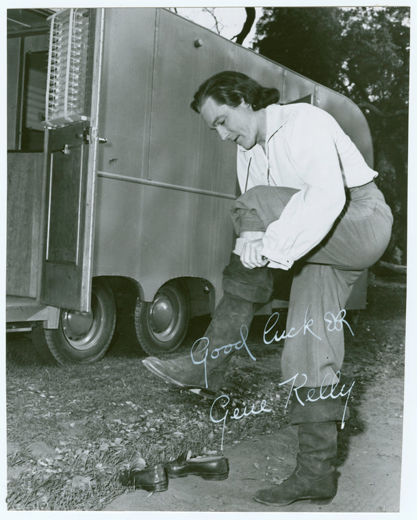 Gene Kelly on the set of The Three Musketeers putting on boot