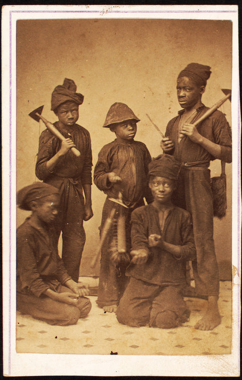 Studio portrait of young chimney sweeps.