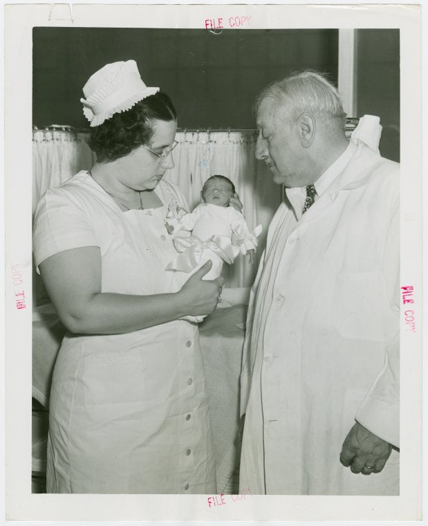 Infant Incubator - Hildegarde Couney holding baby while Martin Couney looks on