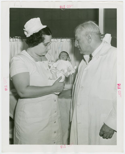 Infant Incubator - Hildegarde Couney holding baby while Martin Couney looks on