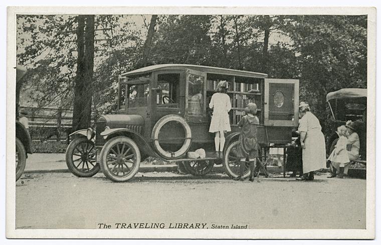 The Traveling Library, Staten Island  [children at side of old truck looking at displayed books]