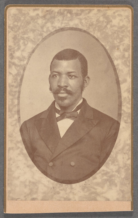 Studio portrait of unidentified man wearing double-breasted jacket