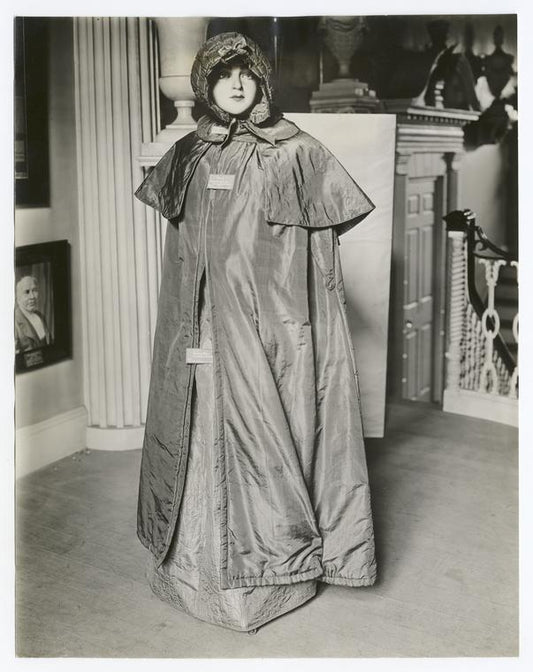 Costume, cloak, olive silk, worn by Mrs. Moses Adams, (Sarah Hubbard). Pumkin hood, quilted plum color silk, from Robbins family of Lexington, Mass.