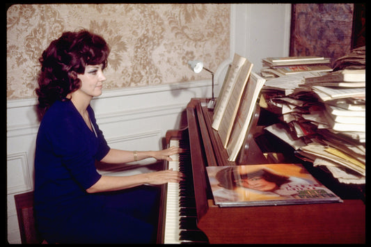 Opera singer Anna Moffo playing the piano in the music room of her eastside brownstone (New York)