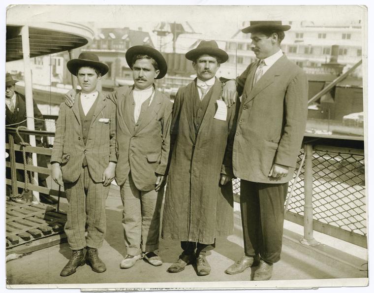 Armenian refugees rescued from Turks by French cruiser arrive in New York, March 9th. 14 year old Peter Gragosian, and three leaders of the refugees arriving in this country.