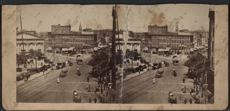 Scenery view of buildings, horse carriages and trolley.