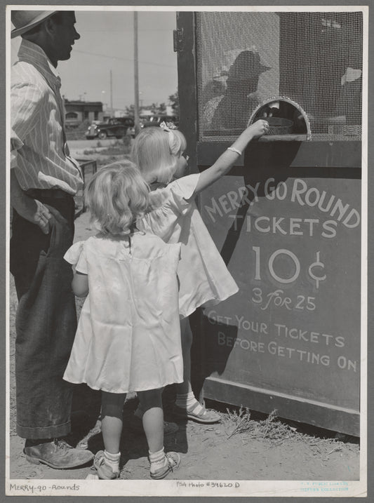 Little girls getting tickets for the merry-go-round at the carnival on the Fourth of July. Vale, Oregon