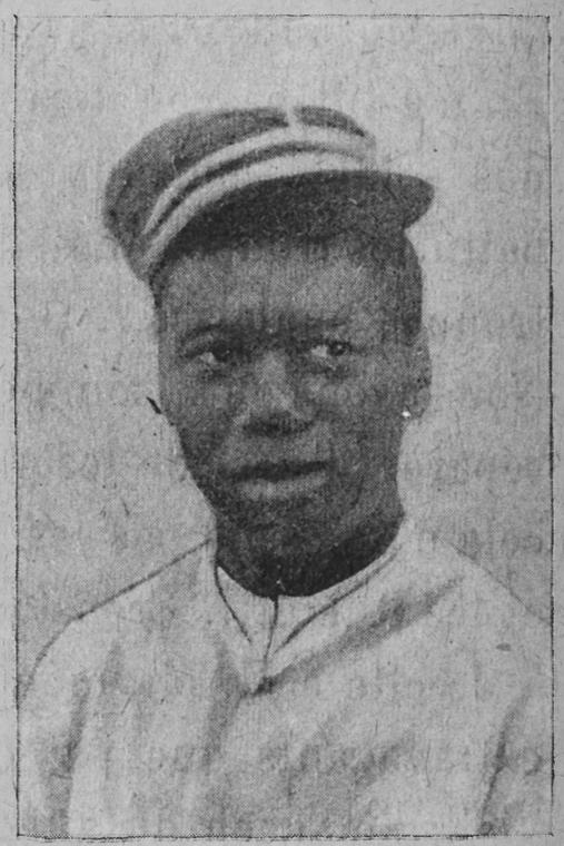 Haitian man wearing a kepi.