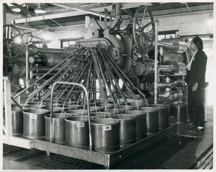 African American woman operating a large piece of machinery.