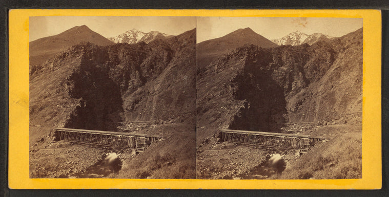 Devil's Gate from the south, the high peaks of the Wahsatch [Wasatch] in the distance. Union Pacific Railroad.