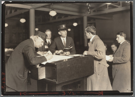 Interpreter and recorder interviewing newcomers, Ellis Island, New York