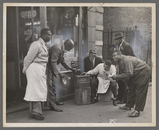 Residents listening to radio outside storefront, circa late 1940s