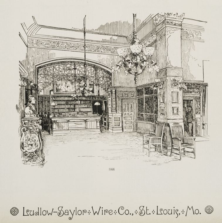 Interior of library with decorative metalwork arch, column, and hanging lamps.