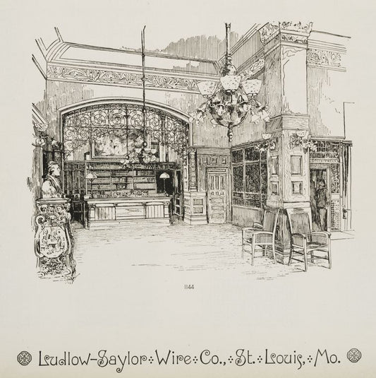 Interior of library with decorative metalwork arch, column, and hanging lamps.