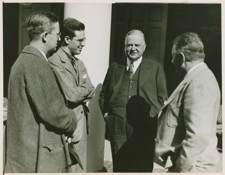 Ex-Pres. Hoover talking with three men.