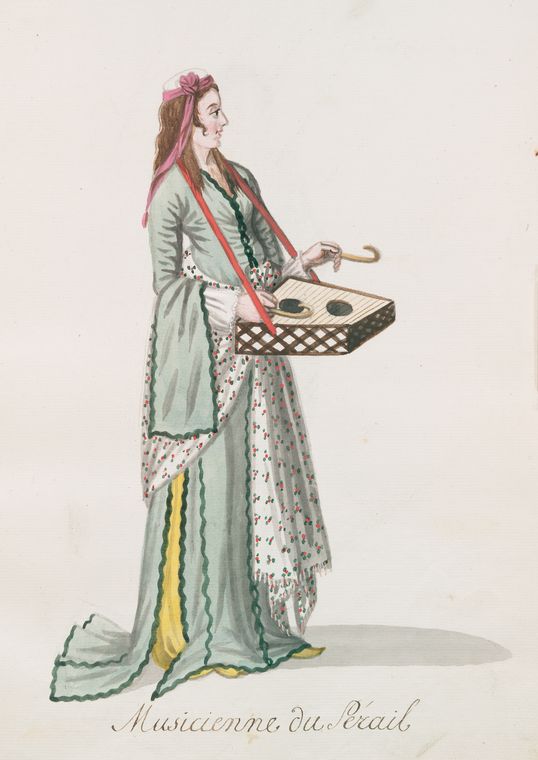 Musicienne du sérail. She holds a type of zither on a harness around her neck and hits the strings with two crooked sticks. [76]
