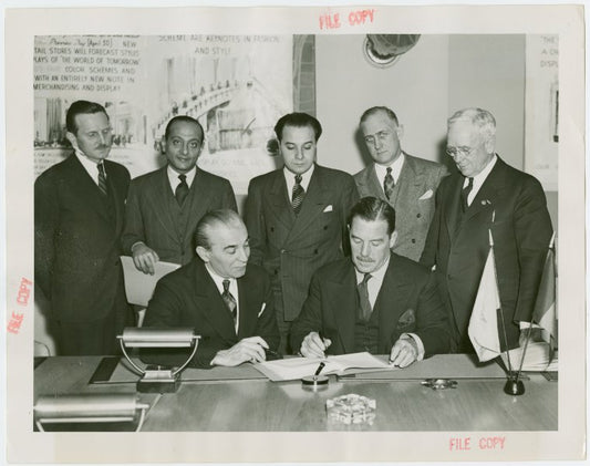 Egypt Participation - Hussein Sabry Pacha (Egyptian High Commissioner) and Grover Whalen sign contract with group looking on