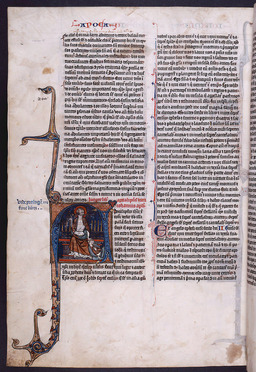 At the opening of Apocalypse, historiated initial by Hand I of John, as if asleep in his vision of Christ with the two-edged sword in his mouth. Note in blue ink for locating prologue