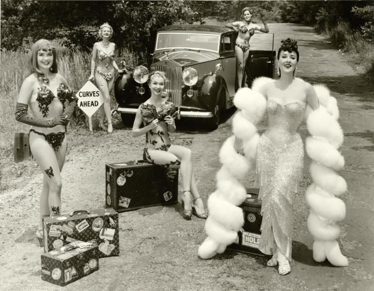 Gypsy Rose Lee on the road with Rolls Royce with Show Girls [curves ahead sign]