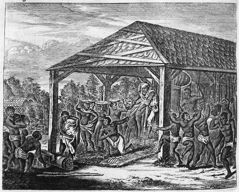 Group of men and women under dwelling participating in rites & ceremony.