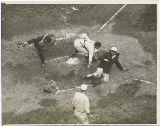 New York Giants player safe at home plate, in a World Series game against the Washington Senators.
