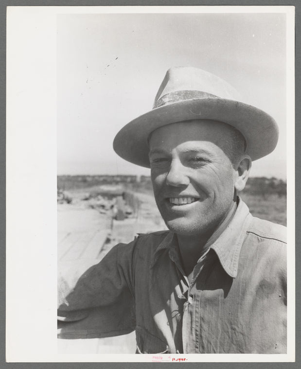 Road worker covered with cement dust, Menard County, Texas