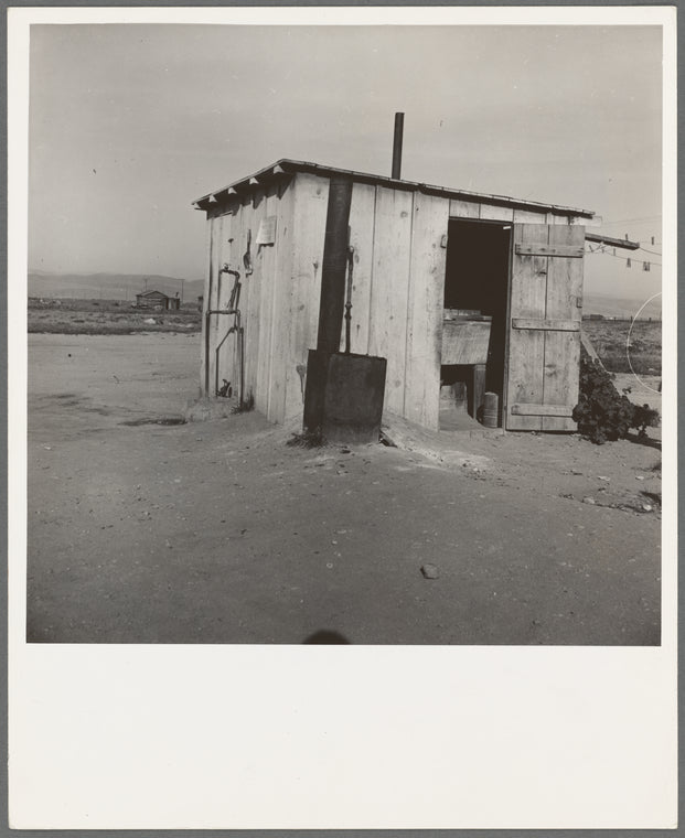Laundry facilities for ten cabins at Arkansawyers auto camp, Salinas Valley, California. Note stove to heat water
