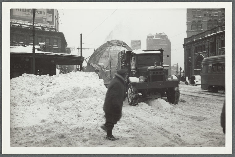 Snow removal on Flatbush Avenue in Brooklyn, near the L.I.R.R. station (at right)