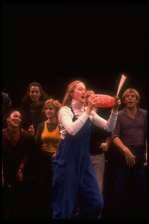 Meryl Streep (as Alice) dancing with a bottle that says "Drink Me" in a scene from the NY Shakespeare Festival production of the musical "Alice"