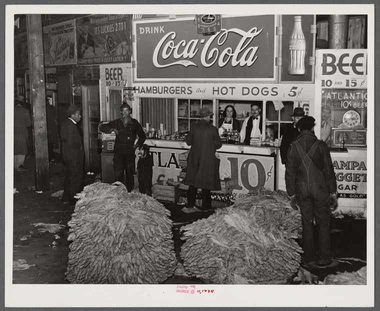 Lunch stand and tobacco inside entrance to warehouse at end of auction sale. Durham, North Carolina