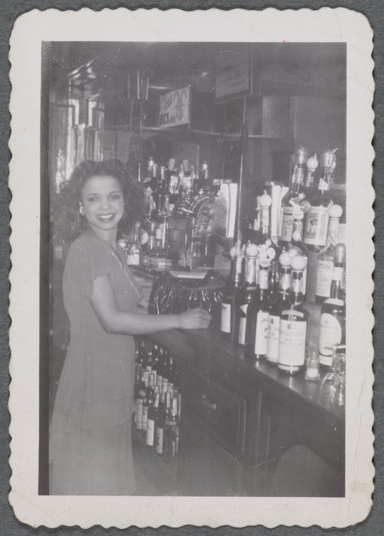 Woman behind bar