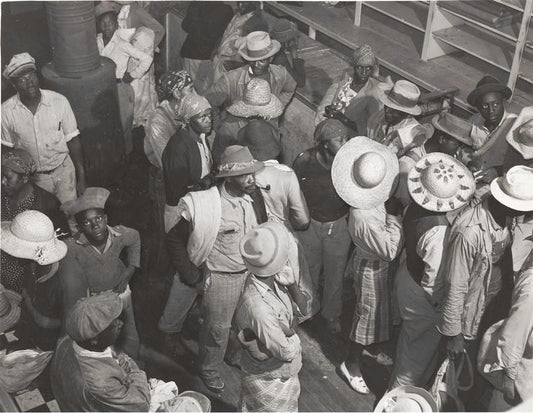 Negro day laborers brought in by truck from nearby towns, waiting to be paid off and buy supplies, for cotton picking inside plantation store, Friday night, Marcella Plantation, Mileston, Mississippi Delta, Mississippi, October 1939.